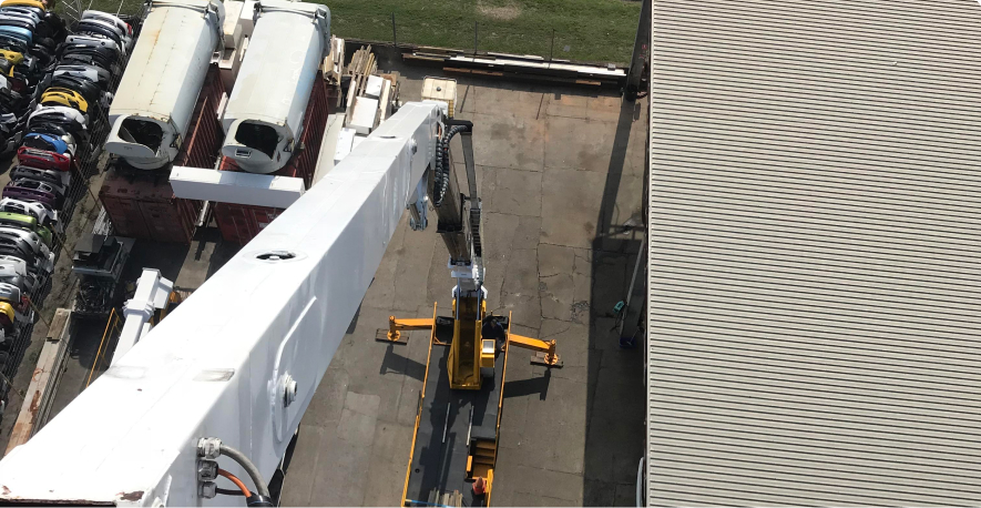 Crane View from Height – A high-angle view of a crane lifting materials at an industrial site. Crane View from Height – A high-angle view of a crane lifting materials at an industrial site.